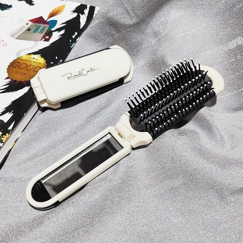 Compact hairbrush with integrated mirror