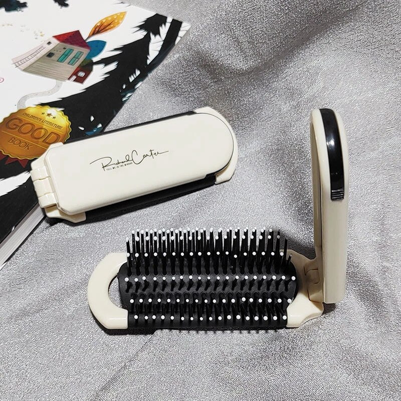 Compact hairbrush with integrated mirror